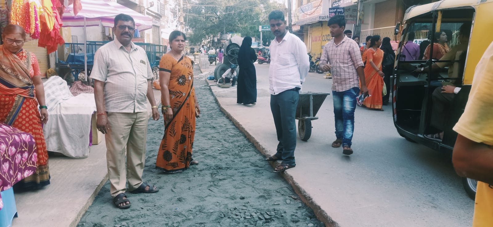 The mayor observed the foot path work near the clock pillar